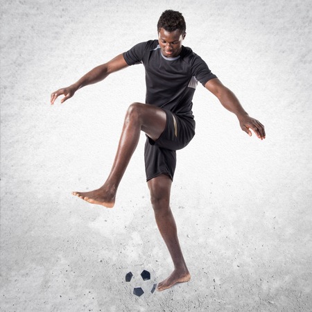 Black man playing footballの写真素材