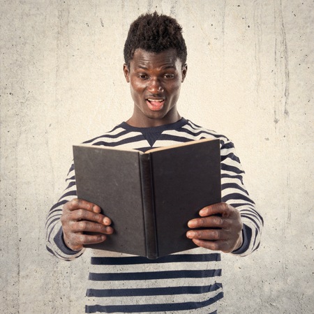 Handsome black man reading bookの写真素材