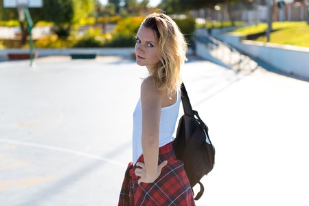 Beautiful woman with backpack outdoorsの写真素材