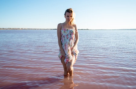 Blonde woman in a beautiful salt lakeの写真素材