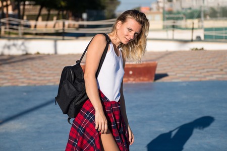 Beautiful woman with backpack outdoorsの写真素材