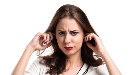 Beautiful brunette girl covering his ears