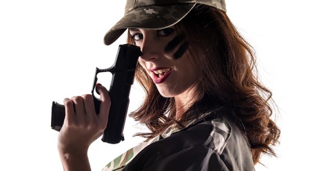 Military girl holding a pistolの写真素材