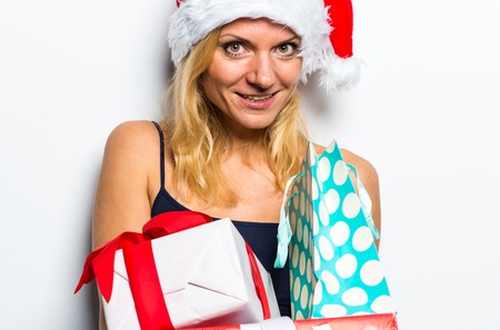 Sexy blonde woman in Christmas custome with a lots of presentsの写真素材