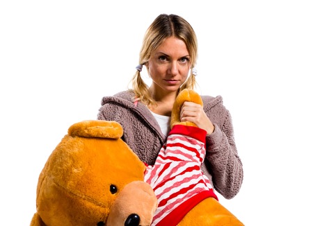 Pretty blonde girl in cute pajamas with big stuffed animalの写真素材