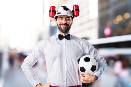 Crazy waiter holding a soccer ballの写真素材