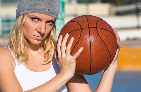 Beautiful woman playing basketballの写真素材