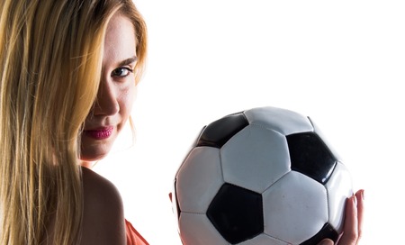 Pretty blonde girl holding a soccer ballの写真素材