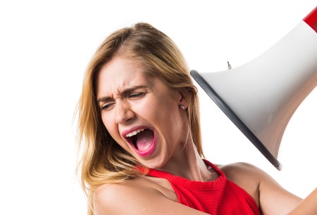 Blonde girl shouting by megaphoneの写真素材
