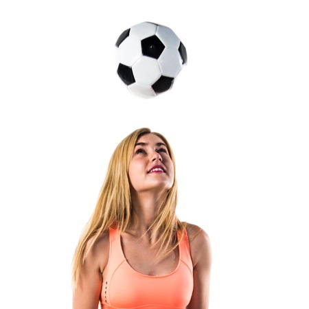 Pretty blonde girl holding a soccer ballの写真素材