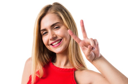 Blonde girl doing victory gestureの写真素材