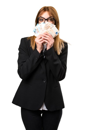 Young business woman taking a lot of moneyの写真素材