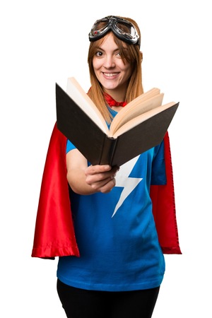 Pretty superhero girl reading bookの写真素材