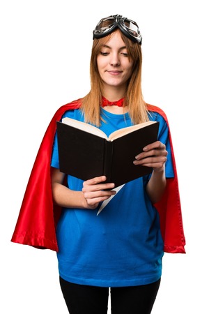 Pretty superhero girl reading bookの写真素材