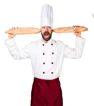 Crazy young baker holding some breadの写真素材