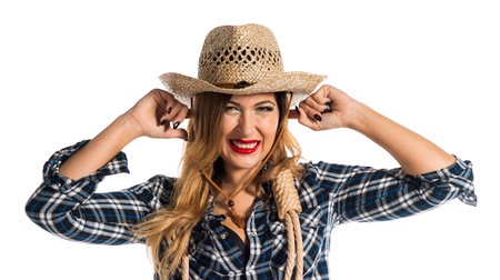 Sexy blonde woman cowgirl covering her earsの写真素材