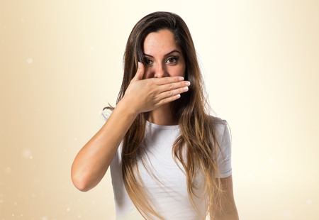 Young pretty girl covering her mouthの写真素材