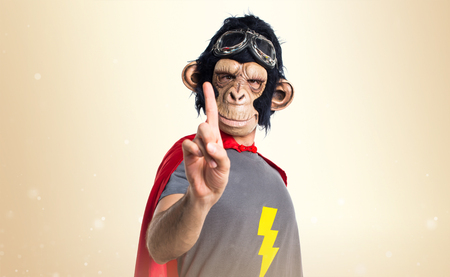 Superhero monkey man counting one on ocher background