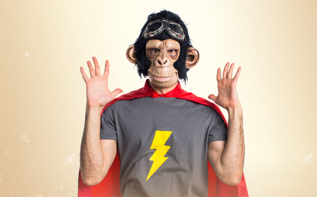 Frustrated Superhero monkey man on ocher backgroundの写真素材