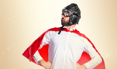Crazy superhero proud of himself on ocher backgroundの写真素材