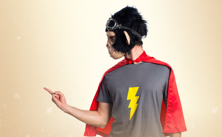 Superhero monkey man shouting on ocher backgroundの写真素材