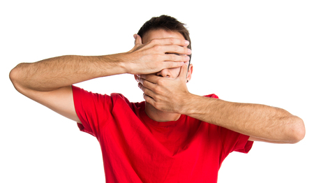 Brunette man covering his faceの写真素材