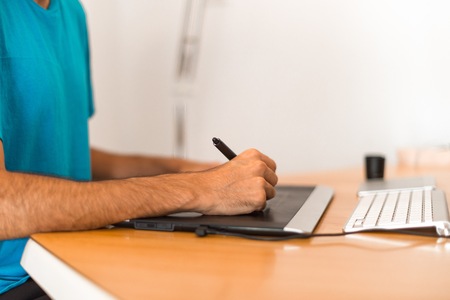 Designer man in an apartment workingの写真素材