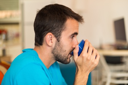 Man in an apartment drinking coffee