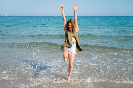 Beautiful young girl at the beachの写真素材