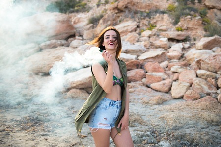 Beautiful girl outdoor with with smoke bombの写真素材