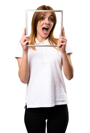 Surprised Beautiful young girl with frameworkの写真素材