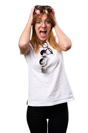 Surprised Beautiful young girl with a lot of glassesの写真素材