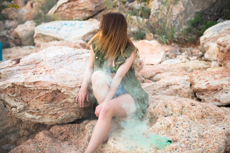 Beautiful girl outdoor with with smoke bombの写真素材