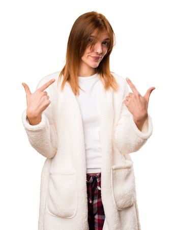Young woman in dressing gown making surprise gestureの写真素材