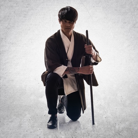 Asian samurai man with katana on textured backgroundの写真素材