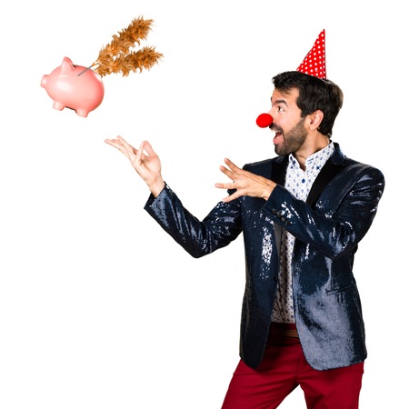 Man with jacket with clown nose doing magic with a pigの写真素材