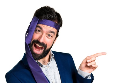 Crazy and drunk businessman pointing to the lateralの写真素材