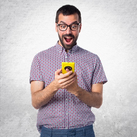 Man with glasses talking to mobileの写真素材