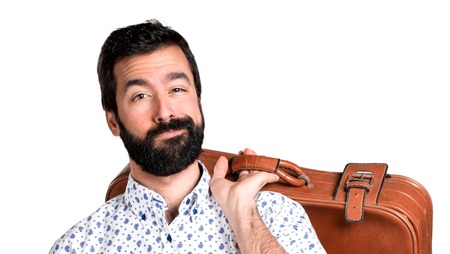 Handsome brunette man with beard holding a vintage  briefcaseの写真素材