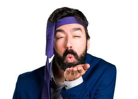 Crazy and drunk businessman sending a kissの写真素材