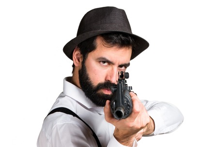 Hipster man with beard holding a rifleの写真素材