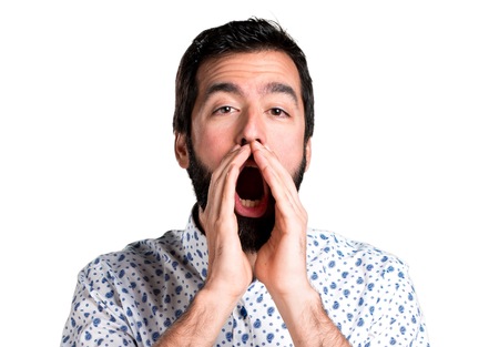 Handsome brunette man with beard shouting