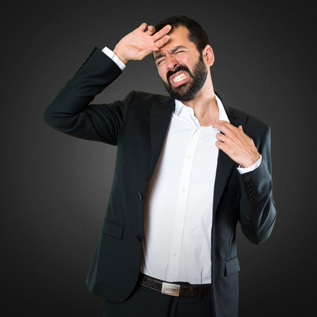 Handsome businessman with fever on black backgroundの写真素材