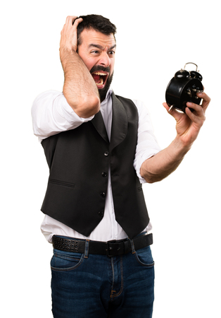 Cool man holding vintage clock on isolated white backgroundの写真素材