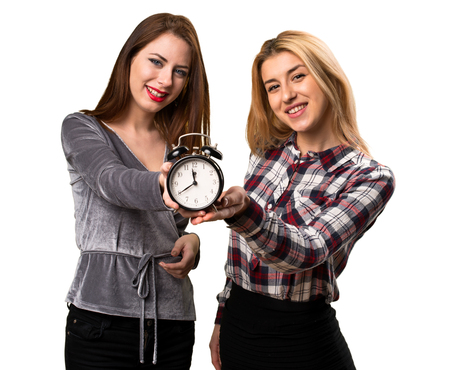 Two friends holding vintage clockの写真素材