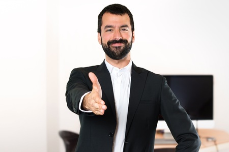 Handsome businessman making a deal in the officeの写真素材