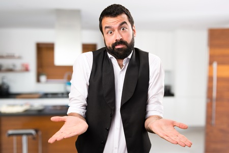 Cool man making unimportant gesture inside houseの写真素材