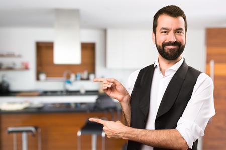 Cool man pointing to the lateral inside houseの写真素材