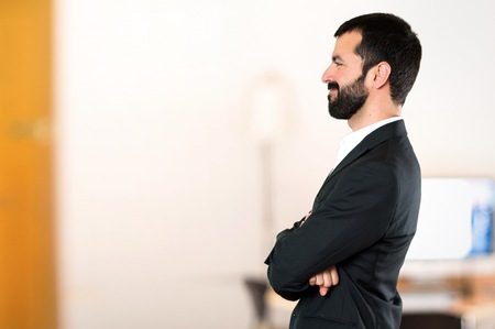 Handsome businessman looking lateral in the officeの写真素材