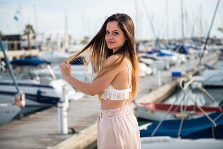 Beautiful young girl in a portの写真素材